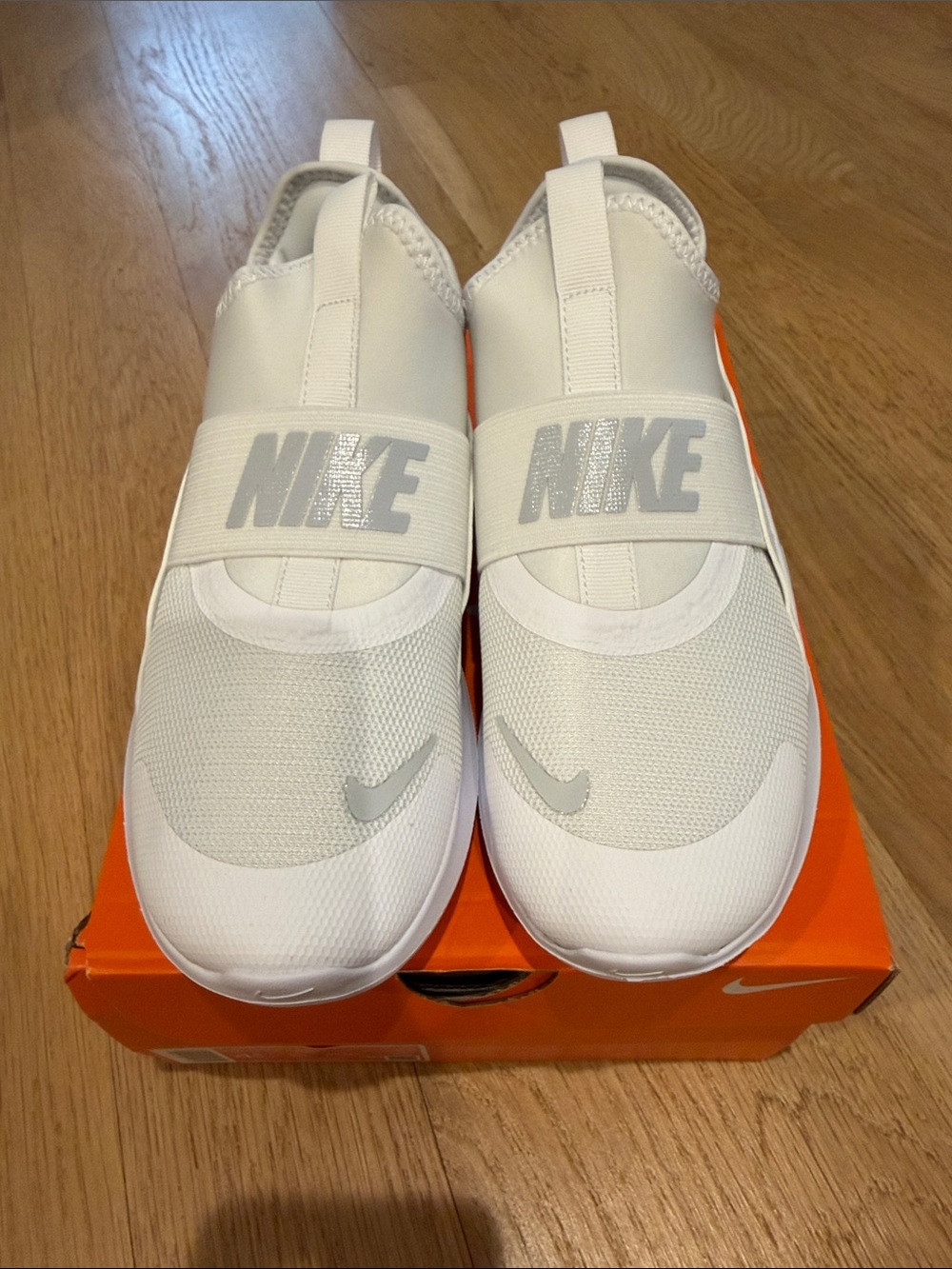 Nike Kids White Slip-On Sneakers with Silver Logo
